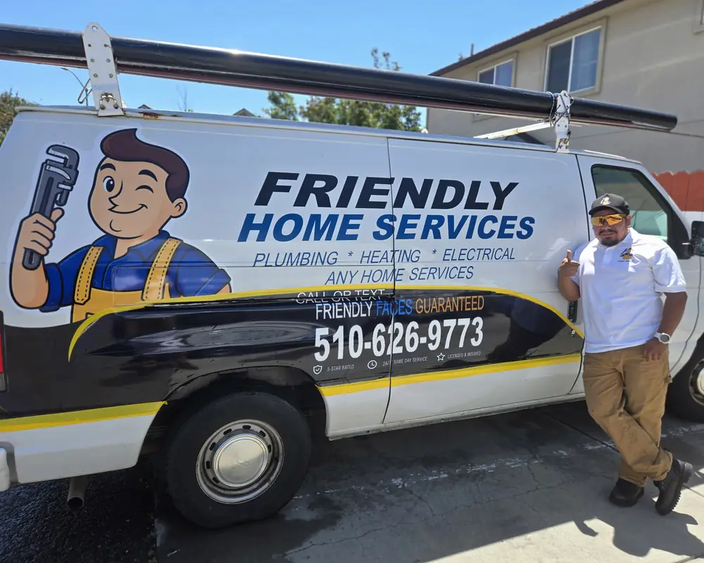 Friendly Services plumber standing next to a branded company van