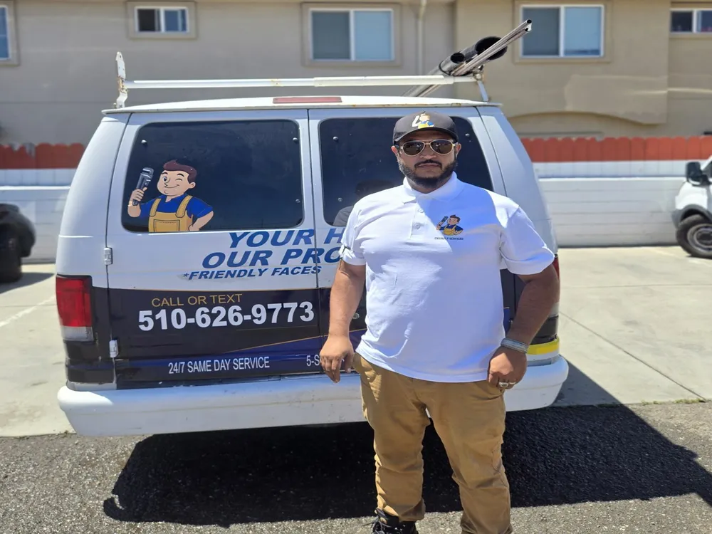 Friendly Services team member at the back of the company van