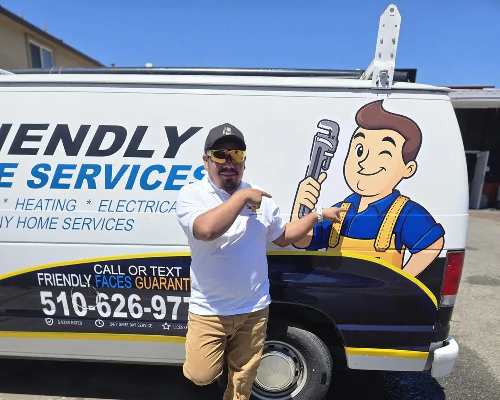 Friendly Services plumber next to the company van and mascot